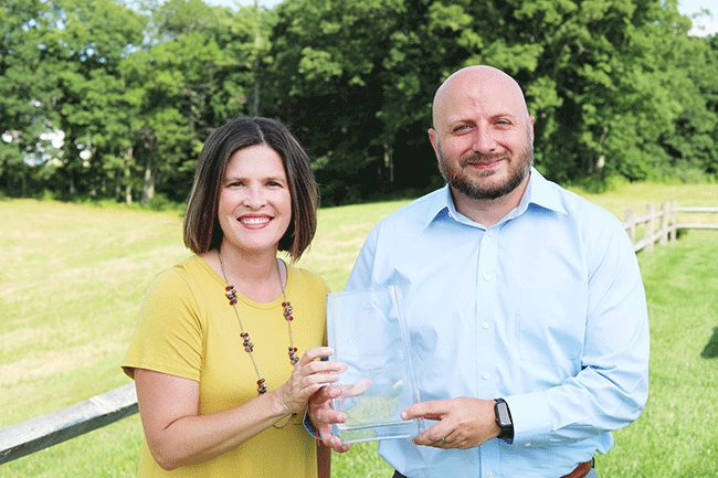 Ben Hatfield receiving his CUAA award from Sarah Turner