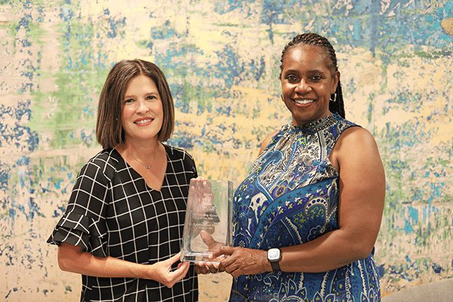 Katrina Terry receiving her CUAA award from Sarah Turner