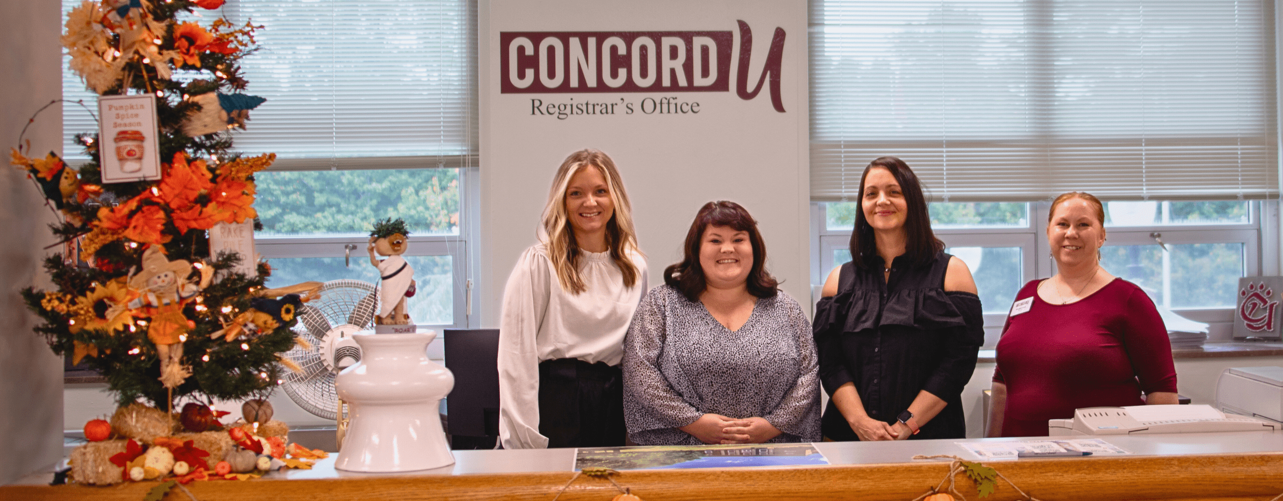 Emily Miller, Brianna Lipscomb, Lucinda Gonderman, and Sheilah Sites pictures behind the Concord University Registrar's Office front desk