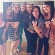 A group of Concord University psychology students posing with a Concord University sign