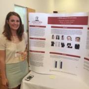 A Concord University Psychology student standing next to her research poster at the CU Research Festival