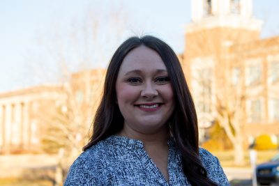 A photo of Chelsea Riffe with Concord's bell tower in the backdrop.