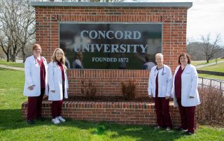 The Department of Nursing Faculty stand together in front of the main Concord University brick sign on the front lawn of the campus. Faculty members include (from left to right) Dr. Michele Holt, Professor Amanda Nichols, Professor Danita Farley, and Dr. Martha Snider. 